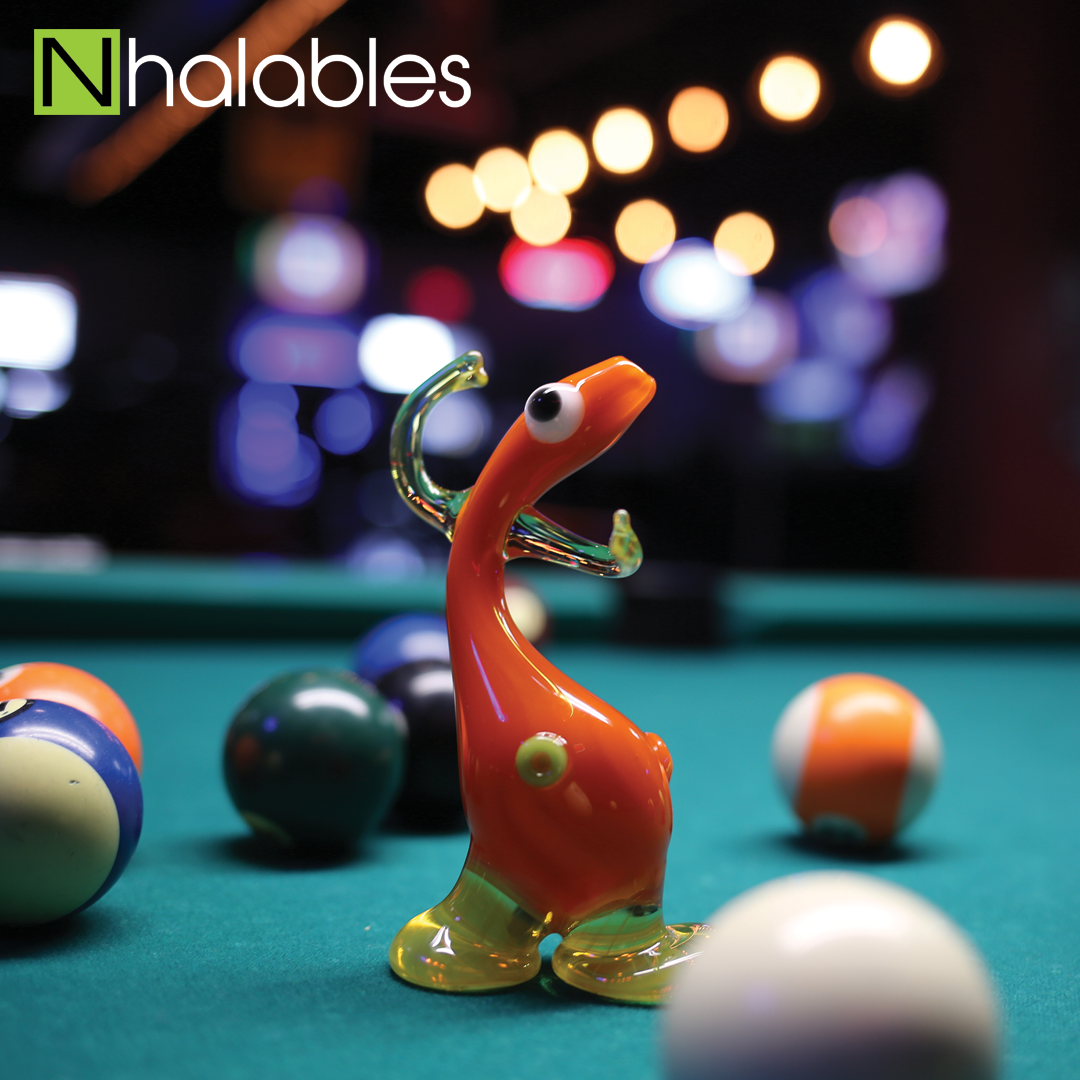 Nhalables Social Post showing a Downeck Glass Spoon sitting on a Pool table in a bar.