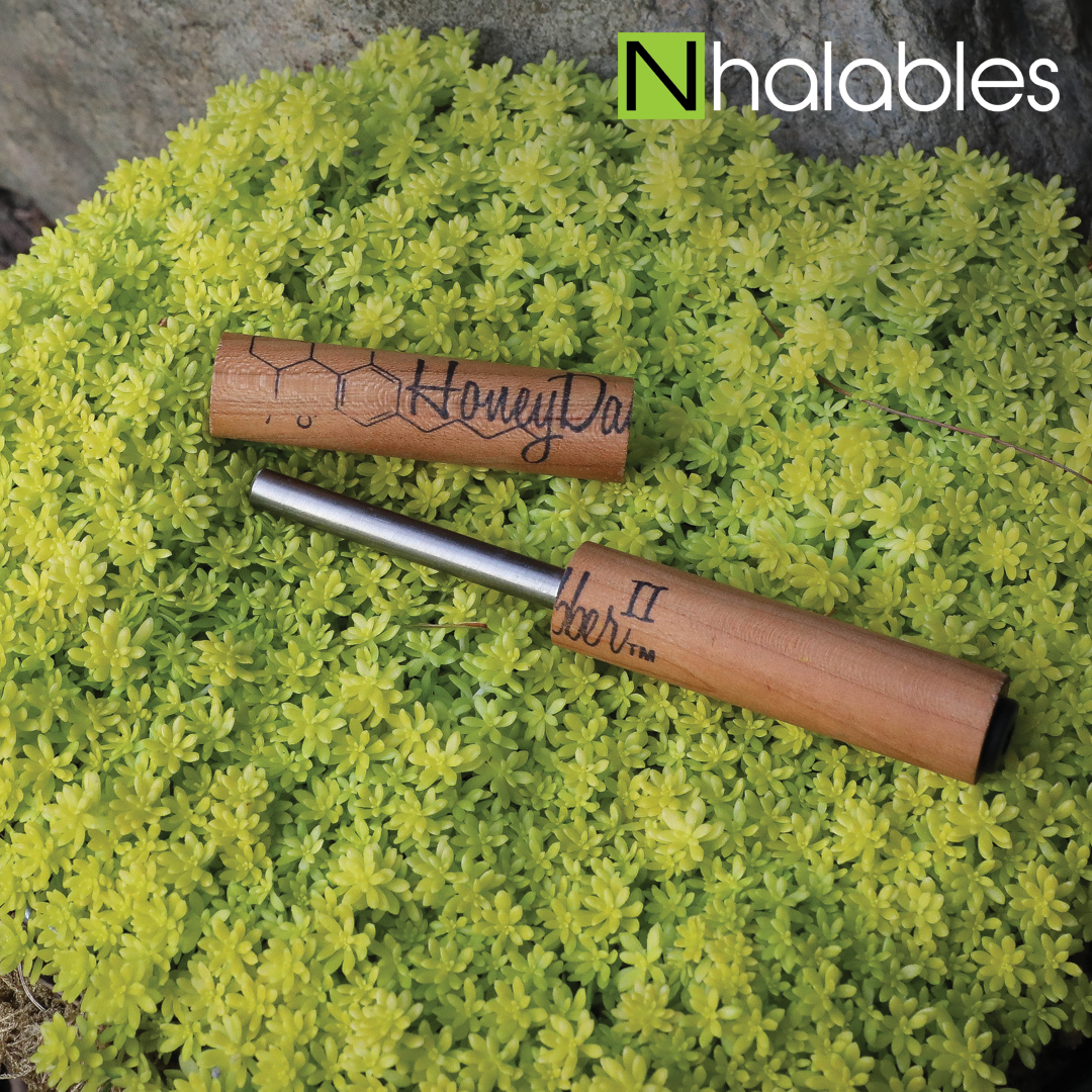 Nhalables Social Picture Showing The Honey Dabber 2 Concentrate Nectar Straw by Honey Labs LLC sitting in a green shrub.