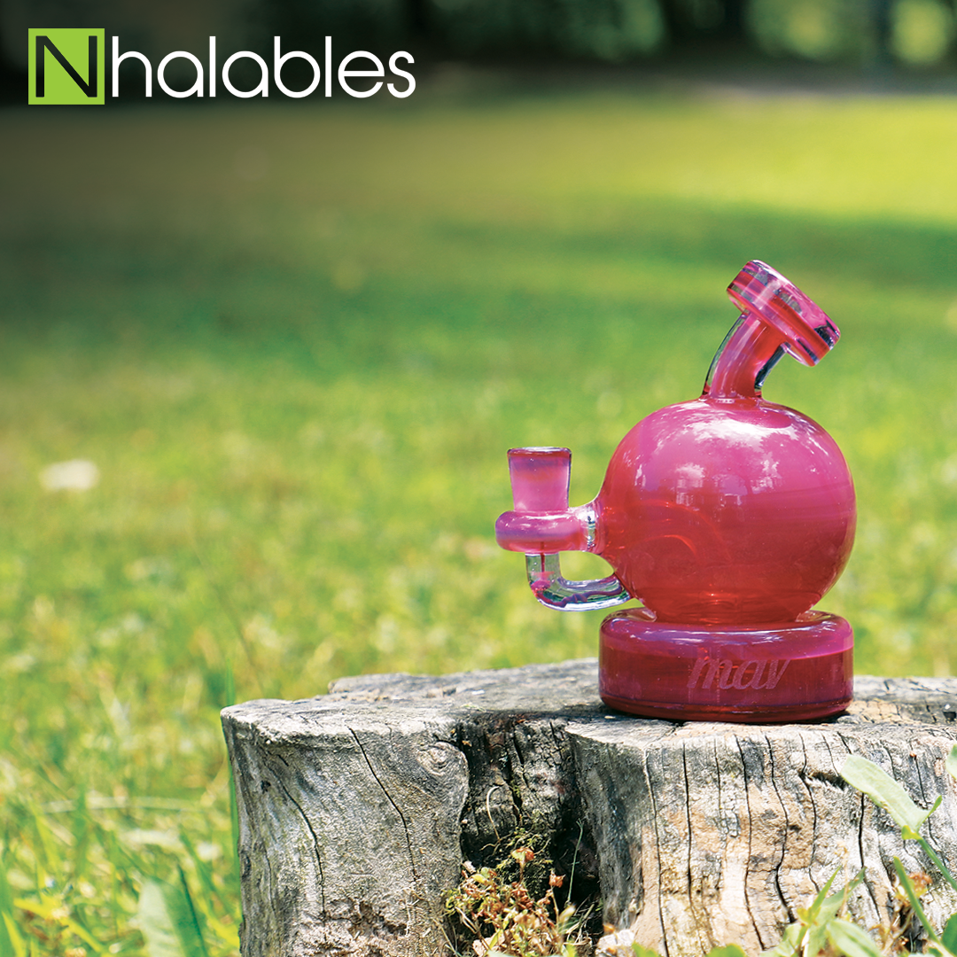 Nhalables Social Post showing a Mav Glass (California) raspberry baby bulb oil rig sitting on a stump with grass in the background.