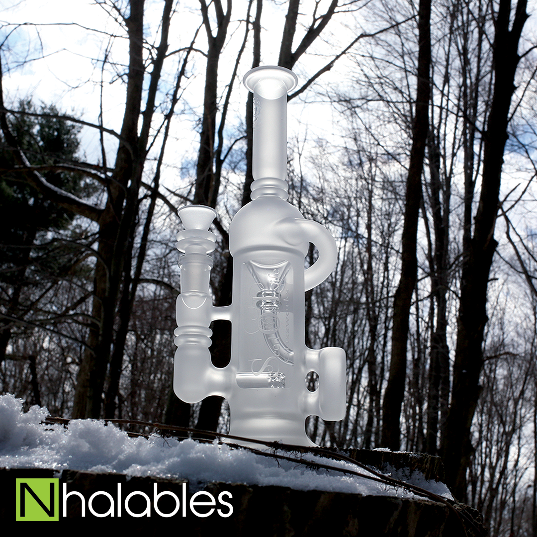 Nhalables Social Post showing a Seed of Life Glassworks Frosted Sol-Cycler Oil Rig Sitting in the snow with trees in the background