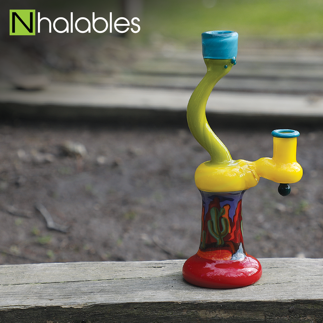 Nhalables Social Post showing a curved desert themed rig by Arizona based Fathead's Glass sitting on a wooden step.