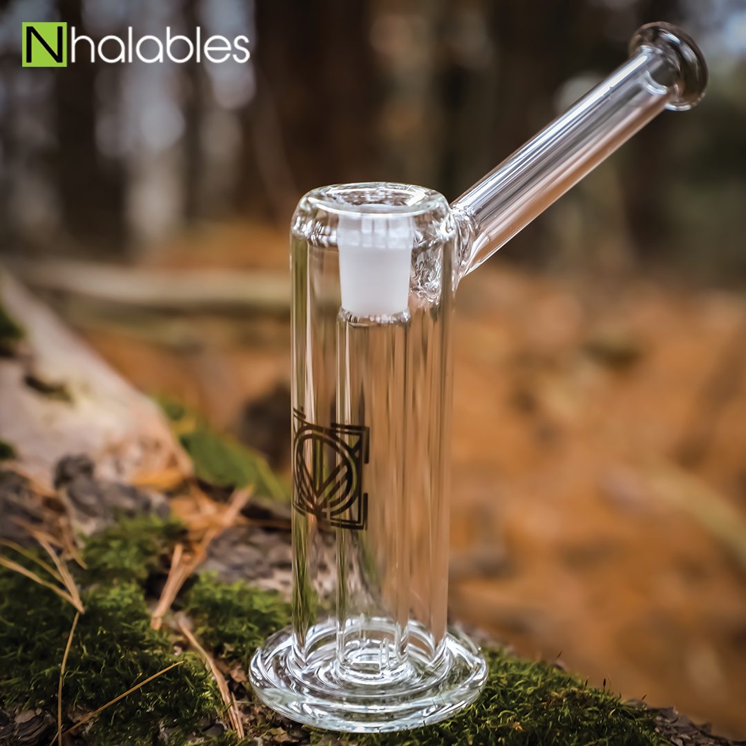 Nhalables Social Image showing a Licit Glass Hammer Bubbler / Rig sitting on a log with moss on it