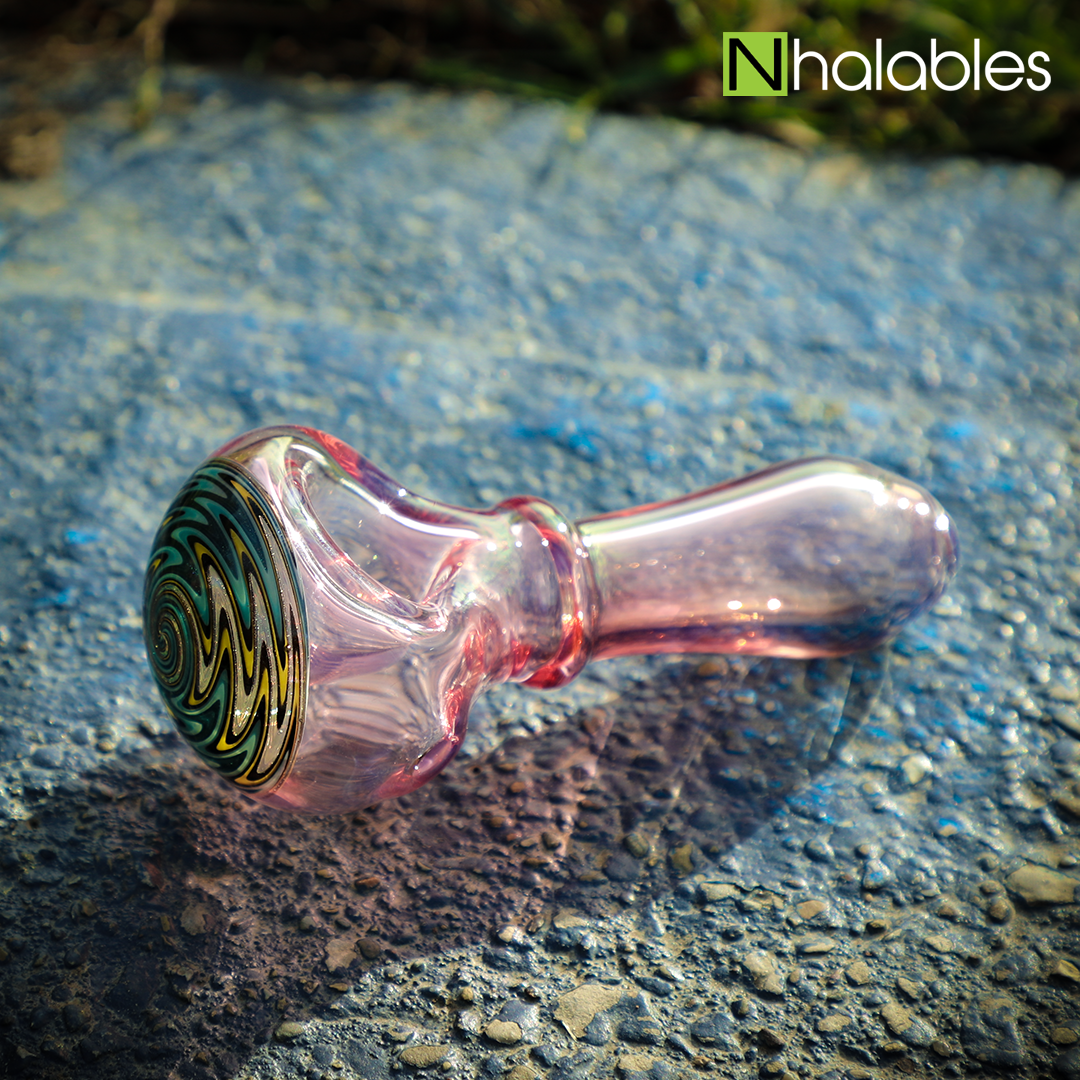 Nhalables Social Posts showing a Hand pipe sitting on a rock by New York based artists "STF Glass" (Buttermilk Studios)