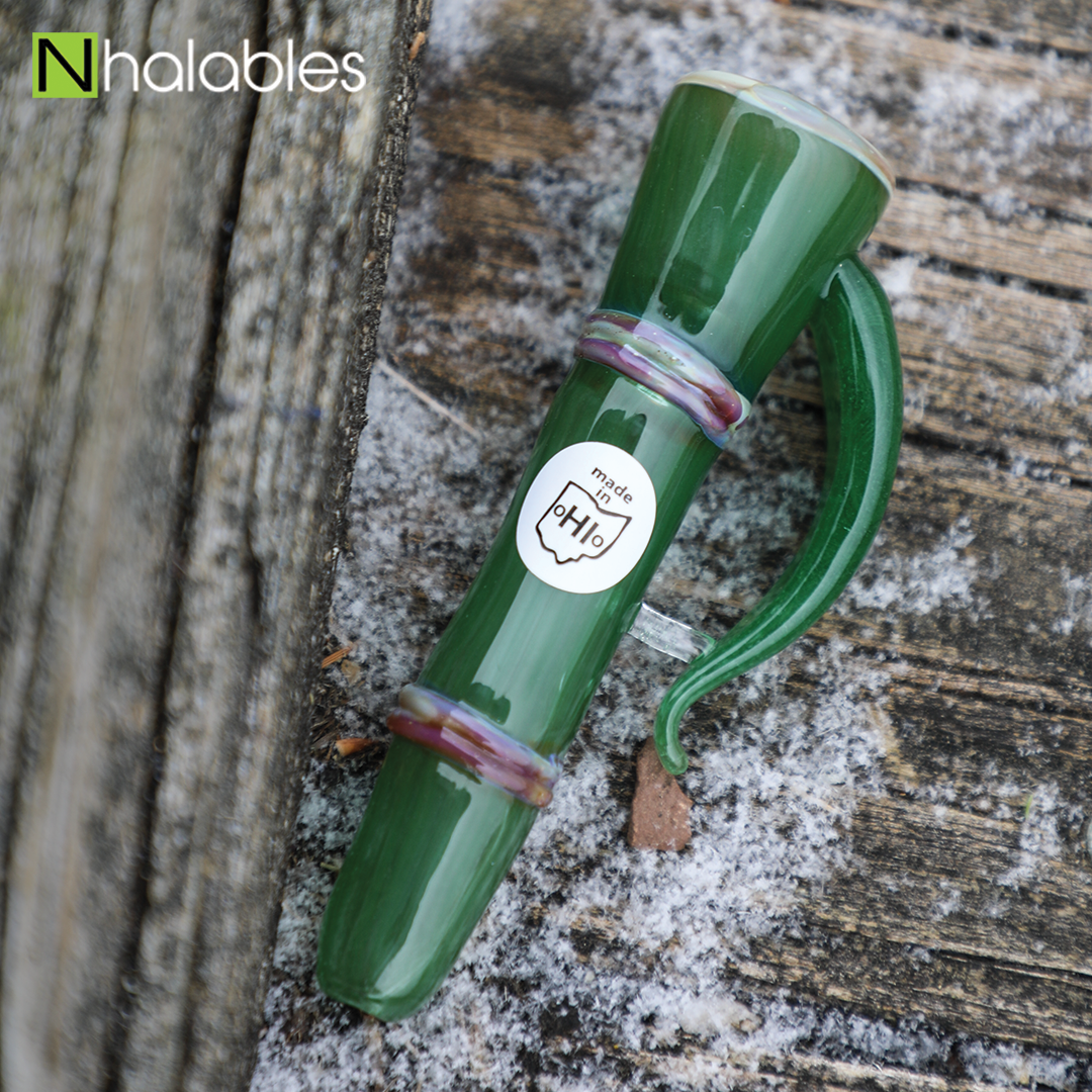 Nhalables Social Image for a Shamboo Chillum by Ohio based Glassblower Shamby Glass sitting on a piece of wood with snow around it