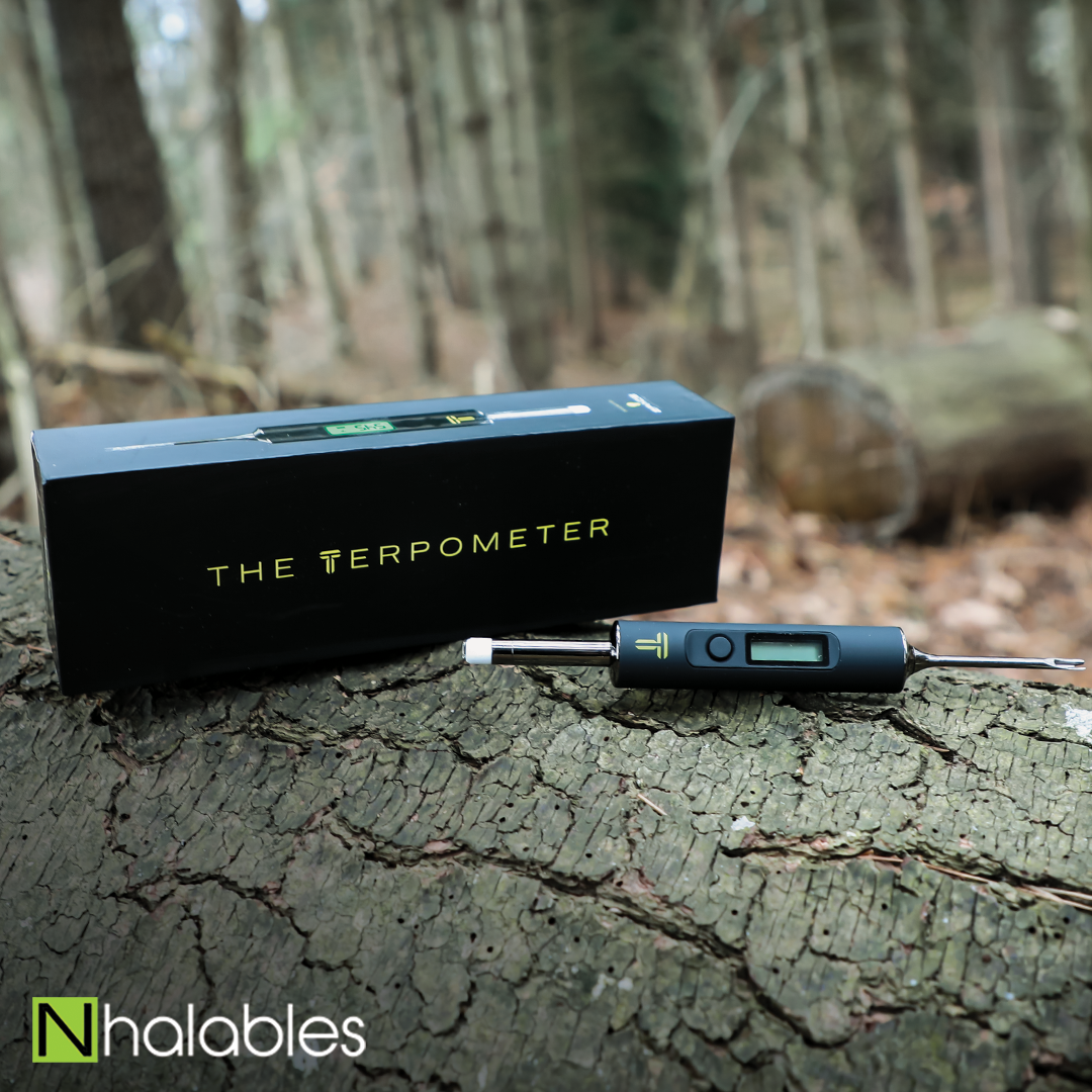 Nhalables Social Post showing a Terpometer Temp Indicating Tool sitting on a log with trees in the background